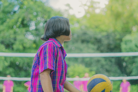 Happiness group of teenage friends playing volleyball in school.の写真素材