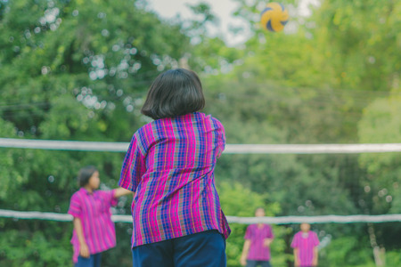 Happiness group of teenage friends playing volleyball in school.の写真素材