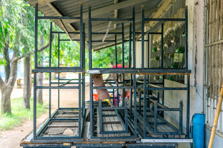 Old broken tables and chairs in school for sale.の写真素材