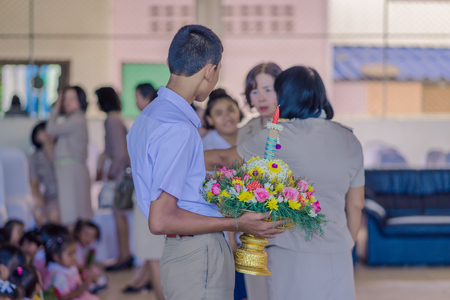 KANCHANABURI THAILAND - JUNE 14 : Unidentified students decorate pedestal tray and flower for give...