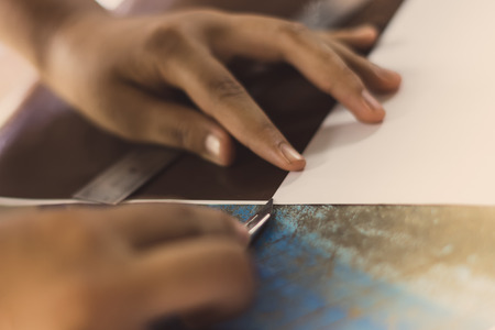 High school students are cutting prints and stickers using knife cutter in school.の写真素材