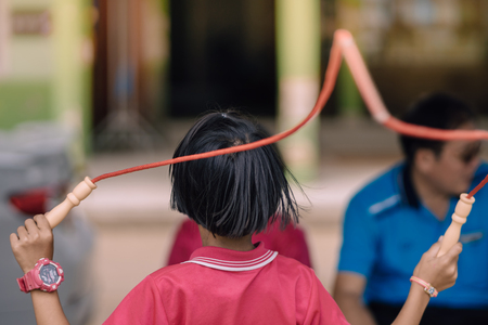Elementary school students enjoy rope jump training for good health before lunch at school.