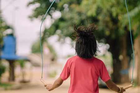 Elementary school students enjoy rope jump training for good health before lunch at school.の写真素材