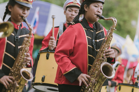 KANCHANABURI THAILAND - JULY 18 :   Thai school marching band on street, in athletic game opening day of primary student in the rain on July 18,2018 at Nongthabong School in Kanchanaburi, Thailandのeditorial素材
