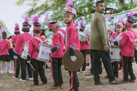 KANCHANABURI THAILAND - JULY 18 :   Thai school marching band on street, in athletic game opening day of primary student in the rain on July 18,2018 at Nongthabong School in Kanchanaburi, Thailandのeditorial素材