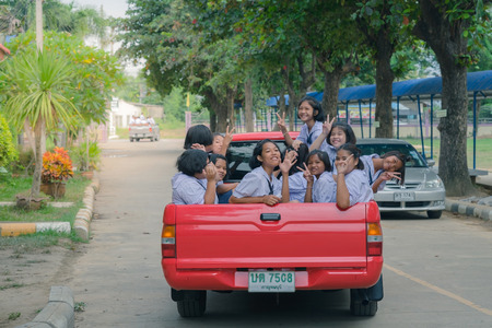 KANCHANABURI THAILAND - JULY 26 :   Students sit in the back of pickup truck to go to temple in traditional lent candle festival for Buddhist Lent Day on July 26,2018 at Watkrangthongratburana school in Kanchanaburi, Thailandのeditorial素材