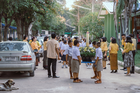 KANCHANABURI THAILAND - JULY 26 : Unidentified teacher and students waited for time to go to temple in traditional lent candle festival for Buddhist Lent Day on July 26,2018 at Watkrangthongratburana school in Kanchanaburi, Thailandのeditorial素材