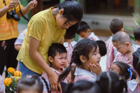 KANCHANABURI THAILAND - JULY 26 : Unidentified teacher and students waited for time to go to temple in traditional lent candle festival for Buddhist Lent Day on July 26,2018 at Watkrangthongratburana school in Kanchanaburi, Thailandのeditorial素材