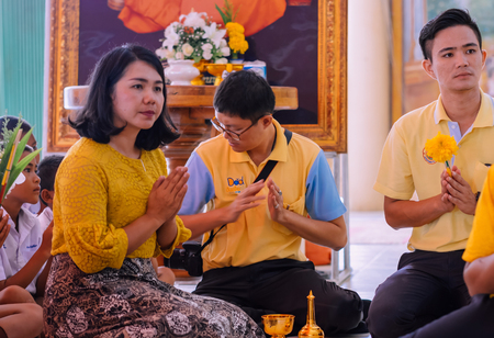 KANCHANABURI THAILAND - JULY 26 : Unidentified Teachers and students  together to make merit and candle light on Buddhist lent day on July 26,2018 at Wat Krang Thong in Kanchanaburi, Thailandのeditorial素材