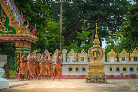 KANCHANABURI THAILAND - JULY 26 : Unidentified Teachers and students  together to make merit and candle light on Buddhist lent day on July 26,2018 at Wat Krang Thong in Kanchanaburi, Thailandのeditorial素材