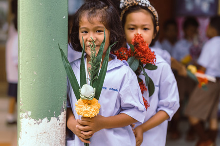 KANCHANABURI THAILAND - JULY 26 : Unidentified teacher and students waited for time to go to temple in traditional lent candle festival for Buddhist Lent Day on July 26,2018 at Watkrangthongratburana school in Kanchanaburi, Thailandのeditorial素材