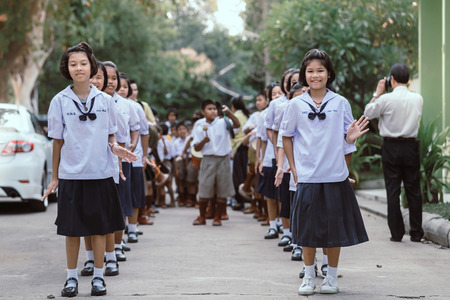 KANCHANABURI THAILAND - JULY 26 : Unidentified teacher and students  participated for Buddhist Lent Day in buddhist culture at Watkrangthongratburana by play a tall narrow drum or called "Tom-Tom" on July 26,2018 at  in Kanchanaburi, Thailandのeditorial素材