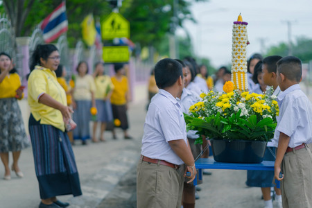 KANCHANABURI THAILAND - JULY 26 : Thai students in candle parade, Buddhist lent candle festival on July 26,2018 at Watkrangthongratburana school in Kanchanaburi, Thailandのeditorial素材