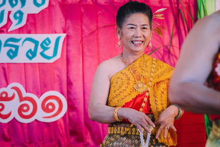 KANCHANABURI THAILAND - SEPTEMBER 28 :   Unidentiffied female teachers perform Thai dance on stage for retirement on September 28,2018 at Watkrangthongratburana school in Kanchanaburi, Thailandのeditorial素材