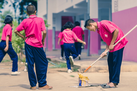 KANCHANABURI THAILAND - SEPTEMBER 20 :  Unidentified students help to build a sepak takraw field border on the cement floor on September 20,2018 at Watkrangthongratburana school in Kanchanaburi, Thailand.のeditorial素材