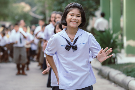 KANCHANABURI THAILAND - JULY 26 : Unidentified teacher and students  participated for Buddhist Lent Day in buddhist culture at Watkrangthongratburana by play a tall narrow drum or called "Tom-Tom" on July 26,2018 at  in Kanchanaburi, Thailandのeditorial素材