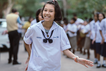 KANCHANABURI THAILAND - JULY 26 : Unidentified teacher and students  participated for Buddhist Lent Day in buddhist culture at Watkrangthongratburana by play a tall narrow drum or called "Tom-Tom" on July 26,2018 at  in Kanchanaburi, Thailandのeditorial素材