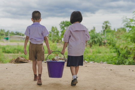 Students help to remove rubbish from the classroom to pile waste in school.のeditorial素材