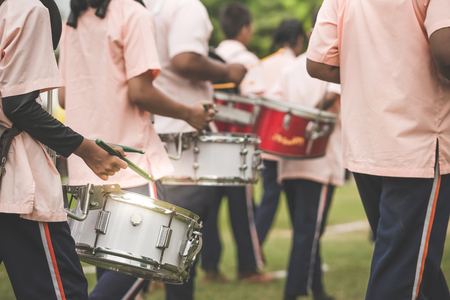 Marching band drummers perform in school paradeのeditorial素材