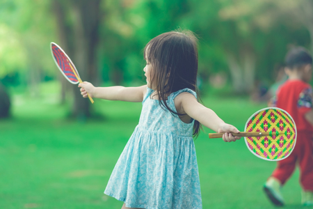 KANCHANABURI THAILAND - OCTOBER 28 : Unidentified litlle girl enjoy with Thai weave colorful fan handle at field on October 28,2018 in Kanchanaburi, Thailand.のeditorial素材