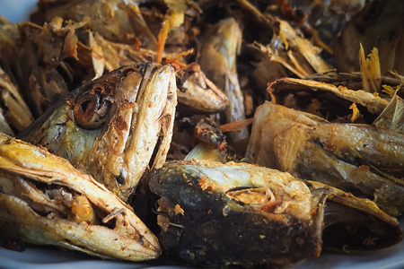 Fried fish heads for a simple meal of rural people in Thailandの写真素材