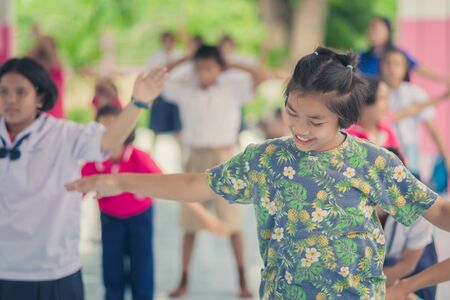 KANCHANABURI THAILAND - JUNE 6 : Unidentified Teachers and students aerobic exercise in the afternoon before go back home on June 6,2018 at Watkrangthongratburana school in Kanchanaburi, Thailandのeditorial素材