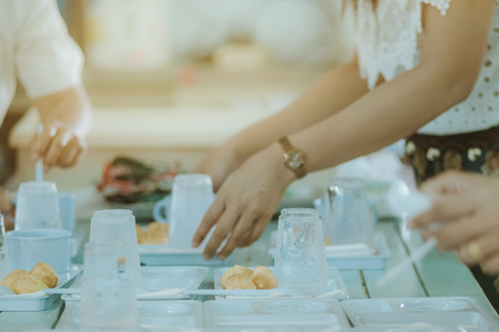 Woman prepare snack and beverage for conference lunch breakの写真素材