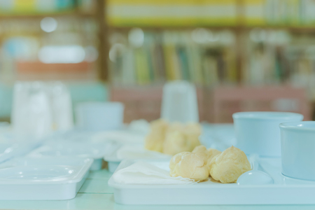 Students prepare snack and beverage for conference lunch breakの写真素材