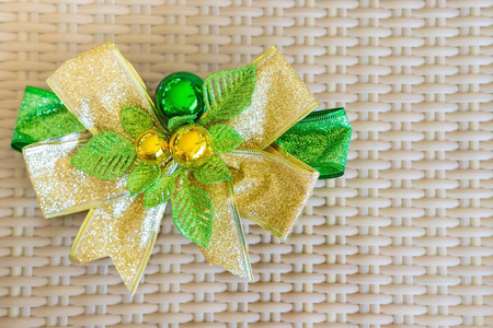 A green ribbon with small ball for decorate on rattan threshing basket.の写真素材