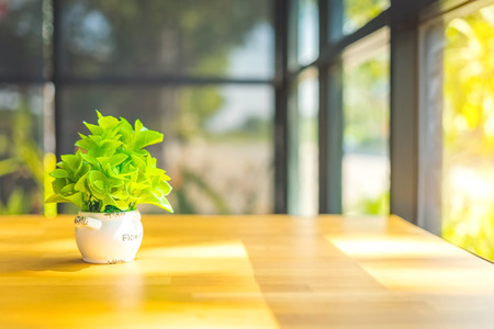 Artificial plants or plastic tree on table for decoration and welcome for customers in  cafe