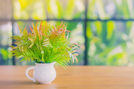 Artificial plants or plastic tree on table for decoration and welcome for customers in  cafeの写真素材