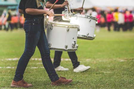 Marching band drummers perform in school paradeの写真素材