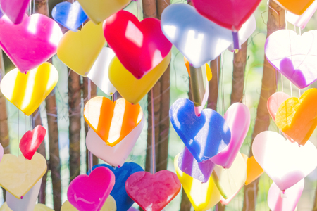 Colorful of hearts made of candle pattern designs hanging from ceiling to decorated on Love Valentines celebration day or wedding day.の写真素材