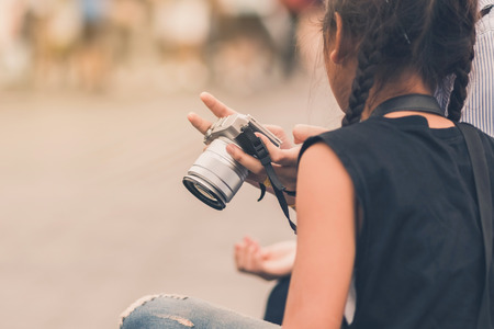 Mom teaches her daughter to taking pictures. Selective focus on hand.の写真素材