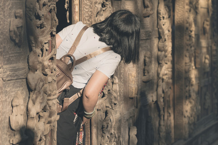 Female tourist take a photo at Shwe Nan Daw Kyaung (Golden Palace Monastery) in Mandalay, Myanmar.の写真素材