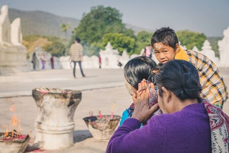 MINGUN-Myanmar, January 20, 2019 : Unidentified tourists make merit, pay homage to blessings at Mya...