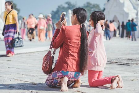 MINGUN-Myanmar, January 20, 2019 : Unidentified tourists walking and photographing at Mya Thein Tan Pagoda on january 20,2019 in Mingun, Myanmar.のeditorial素材
