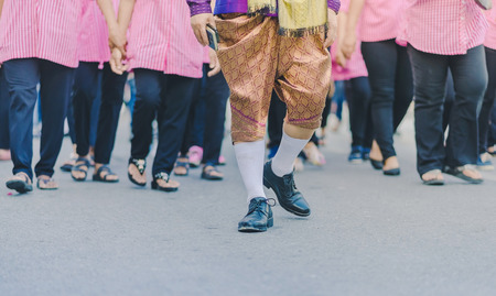 Happiness  villagers dressed in beautiful local costumes join the parade to celebrate Songkran...