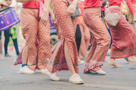 Happiness  villagers dressed in beautiful local costumes join the parade to celebrate Songkran Festival at Ban Nong Khao in Kanchanaburi, Thailand.のeditorial素材