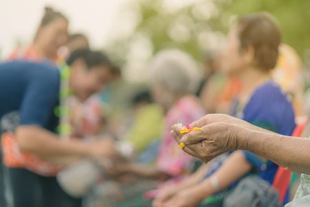 Thai people celebrate Songkran by pouring water and giving garlands to elder senior or respected grandparents and elder and asked for blessings for celebrate Songkran in new year water festivalの写真素材