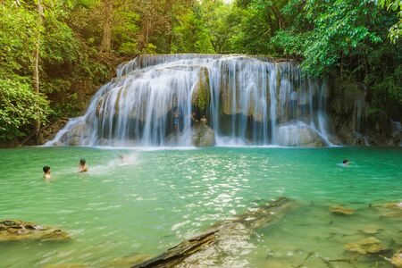 KANCHANABURI THAILAND - NOVEMBER 16 : Many tourists stand in waterfall and taking a shower at Erawan Waterfall on November 16,2018 in Kanchanaburi, Thailandのeditorial素材