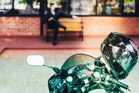 A sporty motorcycle parked in front of a coffee shopの写真素材