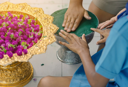 Students help each other to create a flowers tray with pedestal  for The Teachersâ Dayの写真素材