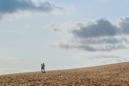 MUI NE, VIETNAM - APRIL 25 : Unidentified tourists relax and take photos on April 25, 2019 at Red Sand Dunes desert in Mui Ne, Vietnamのeditorial素材