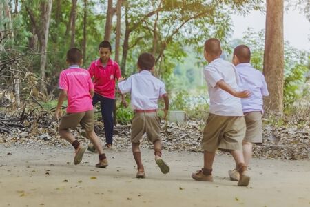 KANCHANABURI THAILAND - FEBRUARY 2 : Unidentified Students enjoy playing old football with their friends on the ground in school on February 2, 2018 at Watch Rangthong Ratburana school in Kanchanaburi, Thailandのeditorial素材