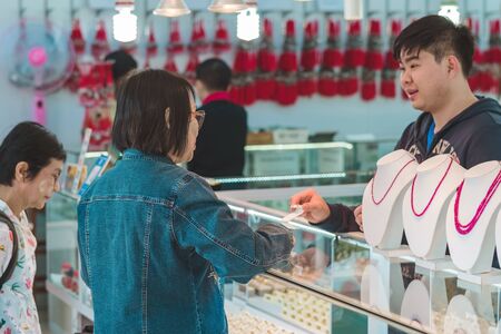 MANDALAY-Myanmar, January 20, 2019 : Unidentified tourists choose to buy jewelry from gemstones at jewelry shop on january 20,2019 in Mandalay, Myanmar.のeditorial素材