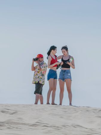 MUI NE, VIETNAM - APRIL 25 : Unidentified tourists relax and take photos on April 25,2019 at white...