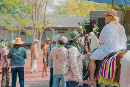 RATCHABURI-Thailand, April 14, 2019 : Unidentified Young man riding horse with music band in...