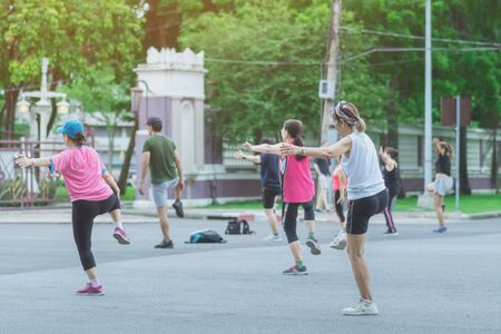Group of elderly friend doing aerobic dance after work   together at Lumpini Park in Bangkok, Thailand.の写真素材