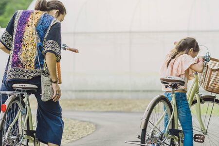 KANCHANABURI THAILAND - OCTOBER 28 : Unidentified Happiness girl and her dad ride bicycle for excerciseon on October 28,2018 at modern organic farmhouse in Kanchanaburi, Thailandのeditorial素材